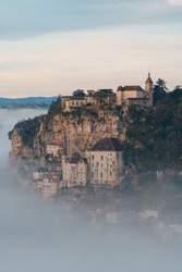 Rocamadour sunrise, Aerial view of the french village and castle on cliff in early morning with fogs in the Canyon of the Alzou