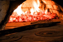 Fire and fire in an old oven and a wooden shovel