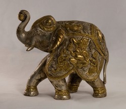 Figurine of an Indian elephant made of bronze on a white background. High quality photo