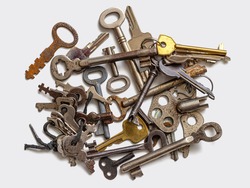 Collection of old used keys from long-broken and lost locks. Key group on a white background