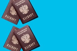 many Russian passports on a blue background, Russian citizenship. Translate: Passport. Russian Federation 