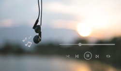 Headphones and playlist listen to music at sunset