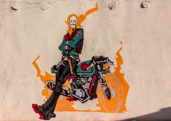 The graffiti of ghost rider with his bike on a wall of a cafe in Ladakh, India. Natural beauty of Ladakh in India. Snow mountains of Ladakh. Famous tourist place in the world. Travel Photography. 