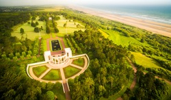 Aerial view to dramatic normandy coast with memorial to dead american soldiers of WW2