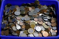 Close up of a collection of old coins kept at a roadside vendor's shop for sell in a tray