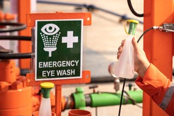 Clean water bottle at emergency eye wash station, using in case of accident to washing personal's eyes when toxic chemical was spilled into eyes. First aid kit for industrial working object photo.