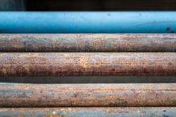 Rustic metal pipe which is used as chemical flowing transfer line in refinery plant process. Industrial equipment object photo. Close-up and selective focus at center part.
