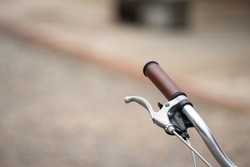 Handlebar and braking system part of a vintage style bike or bicycle with copy space. Transportation and sport equipment object photo, close-up and selective focus.