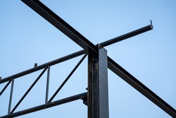 Balance beam and roof structure of the warehouse during it building. Construction building and industrial material photo.