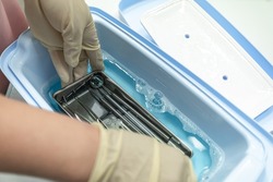 Hands are cleaning medical instruments. Disinfection of a dental instrument. Dental office