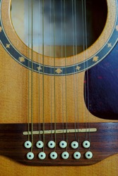 12-string electro-acoustic guitar, bridge detail, violin