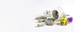 Long wide banner with natural herbal pills for detox and immunity support in pandemic time. Big herbal pills in white plastic bottle on white background with copy space for your text.