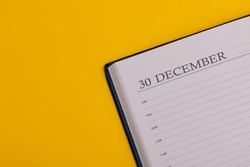 Notepad or diary with the exact date on a yellow background. Calendar for December 30 - winter time. Space for text.