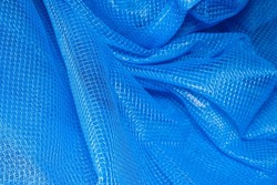 background texture Closeup of blue netting. Abstract background with intersection of nylon threads at high magnification.