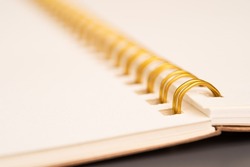 selective focus. gold spiral notebook isolated. Notebook with gold spiral.