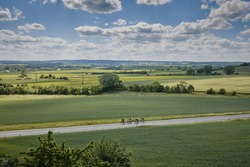 Racing cyclists enjoy the summer on a quiet country road