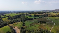 Aerial view of farmland and countryside with trees and fields. Taken in Lancashire England. 
