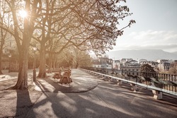 Sunrise on the world's longest wooden bench and children's playground in Geneva, Promenade de la Treille.