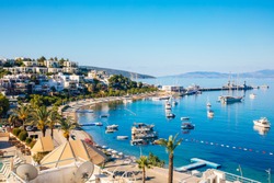 View of Bodrum Beach, Aegean sea, traditional white houses, flowers, marina, sailing boats, yachts in Bodrum town Turkey. 