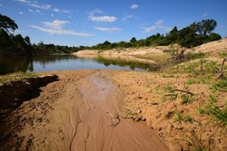 The soil on the shores of lakes or rivers is shallow because of the erosion of currents. causing nearby soil to flow into a lake or river There was a problem of shallow rivers, water shortages, and dr