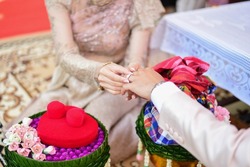 Engagement ceremony and Thai wedding ceremony. Thai Buddhist style. The concept of wearing an engagement ring. Isaan Thai wedding