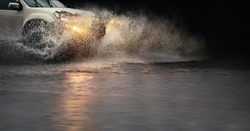 Stop motion, high resolution image of 
 splash by a car through flood water after hard rain.