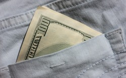 American money in the back pocket of blue jeans. Close-up of 100 dollars banknote.