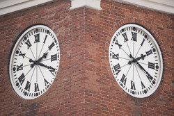 Clock on the brick tower. close up. vintage. big clock on the street.