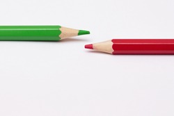 two pencils of green and red, symbolize the opposite