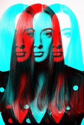 Abstract beautiful woman with long dark hair and retro blouse with white dots studio portrait in rgb channel color split effect. Due to red and blue color reflection head looks like extraterrestrial