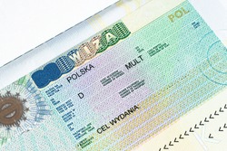 Fragment of Schengen multi entrance Polish visa in passport close-up. Travel Polish visa.