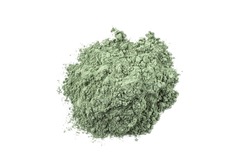 Dry green cosmetic clay isolated on white background. Heap of natural organic green cosmetic clay.