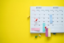 close up of calendar on the yellow background, planning for business meeting or travel planning concept