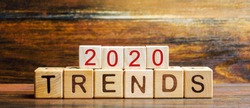 Wooden blocks with the word Trends 2020. Main trend of changing something. Popular and relevant topics. New ideological trends of fashion. Recent and latest trend. Evaluation methods. Fashionable