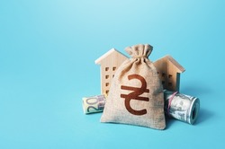 Houses and ukrainian hryvnia money bag. Building up capital, saving from inflation risks. Real estate. Declaration, taxes payment. Bookkeeping and accounting. Asset, financial resource management.