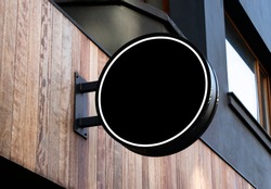 circle mockup of street store template signboard on empty wood wall