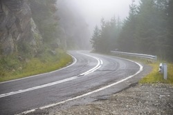 Winding road and fog. Dangerous road. Dangerous driving conditions meteo