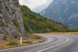Sharp turn of the road with a sign of falling stones. Balkans, Montenegro