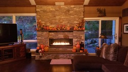 Large Stone Fireplace with Flames, at Dusk in a Rustic Home During the Fall Season