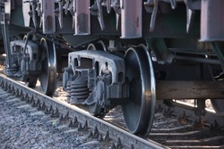 wheels of a railway train on rails close up, cargo transportation