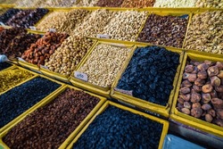 Selective focus on dry fruit mix on food market, colorful dry fruits, dried fruits, nuts, different types of dry fruits, Assortment of dried fruits at market. 