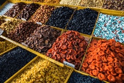 Selective focus on dry fruit mix on food market, colorful dry fruits, dried fruits, nuts, different types of dry fruits, Assortment of dried fruits at market. 