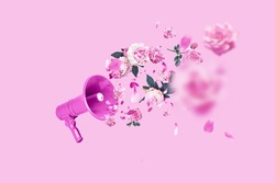 Pink creative megaphone and flat pink flowers roses and peonies on a pastel pink background. Concept creative idea of spring and women's day. Flora, flowers and beauty