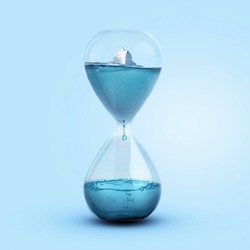 Time and Melting Glaciers, Concept. Iceberg melting in a glass clock. Pollution and global warming, a creative idea