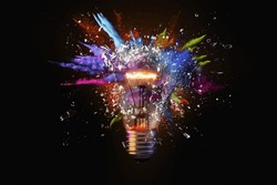 Electric light bulb exploding with paint and glass, a creative idea. Business and technology. Think different, concept. New thinking and brainstorming