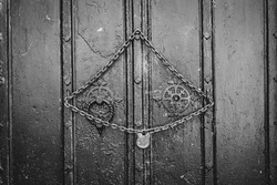 Lock and chain on old wooden vault door