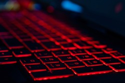 HP omen keyboard with red back lit keys with a shallow depth of field