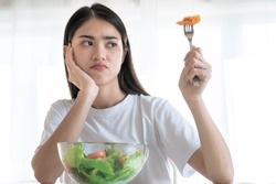 Asian women are not happy, She doesn't want to eat vegetables.