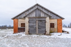 Old Wooden Shed Doors Exterior on White Brick Wall in Winter