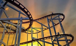 Steel rails for driving roller coasters in circular motions, on background evening sky and sun shining, concept relaxation and holiday of fun excitement and extreme activity in open air.